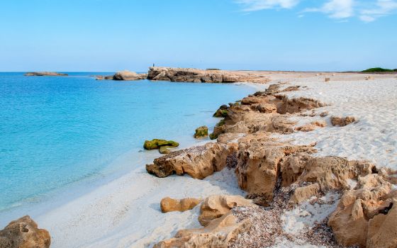 Weisser Quarzstrand mit Felsformationen und türkisblauem Wasser am Strand Is Arutas – Westküste Sardiniens.
